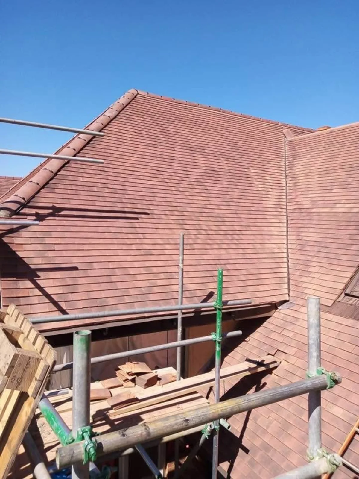 Restored handmade clay peg tile roof with lead valleys on a period townhouse in Sudbury, Suffolk