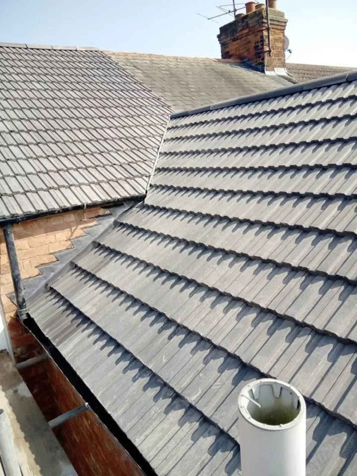 Renewed slate roof valley with new code-graded lead flashing on a High Street cottage in Kelvedon, Essex
